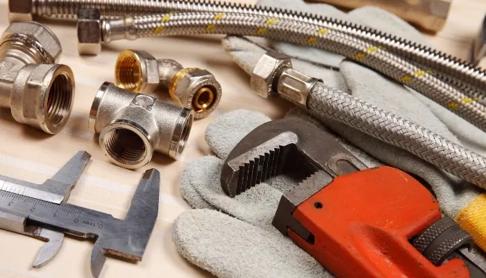 Plumbing fittings, braided supply lines and a pipe wrench